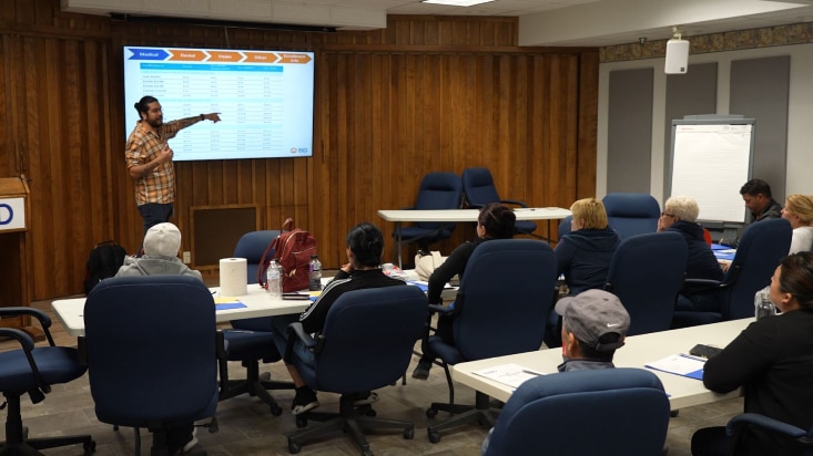 Male BD associates conducting an english as a second language class to new spanish-speaking BD associates