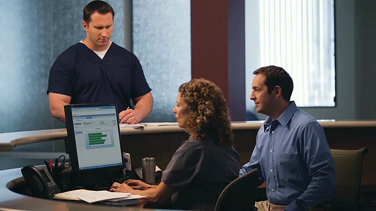3_people_at_desk